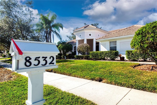 mediterranean / spanish home featuring a front yard