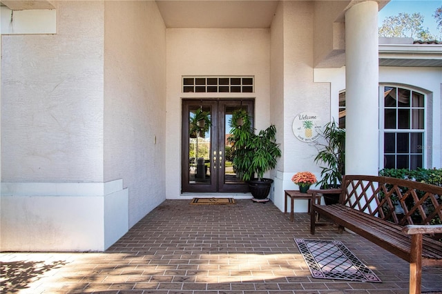 view of exterior entry featuring french doors