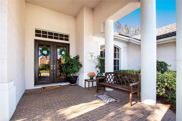 view of exterior entry featuring french doors