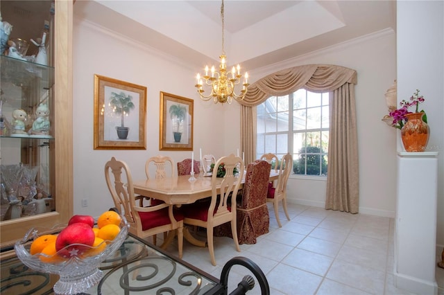 tiled dining area featuring a tray ceiling, crown molding, and an inviting chandelier