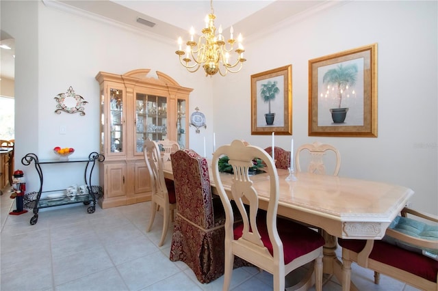 tiled dining area with an inviting chandelier, plenty of natural light, and ornamental molding