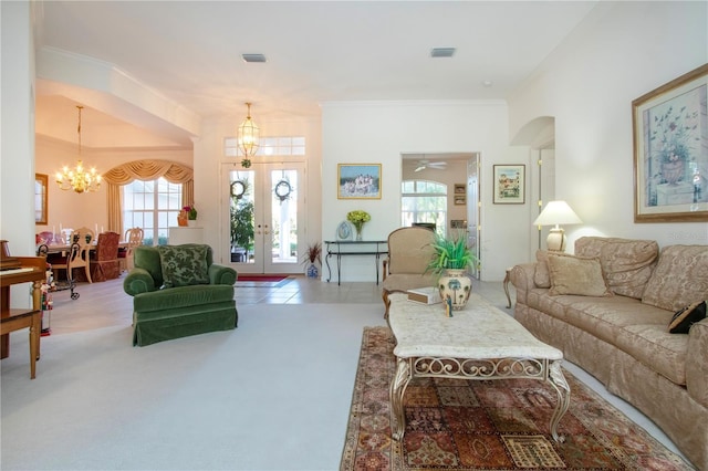 living room featuring carpet floors, crown molding, and a wealth of natural light