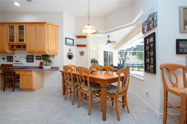 dining area featuring light tile patterned floors and ceiling fan