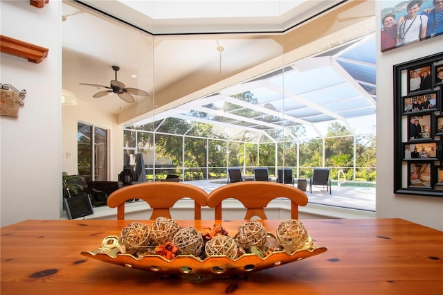 sunroom featuring ceiling fan and a pool