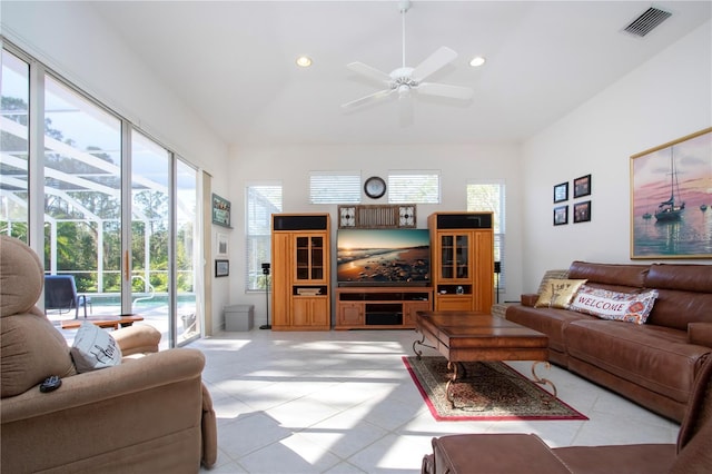 living room with a towering ceiling and ceiling fan