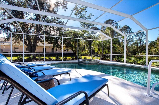 view of swimming pool with a lanai and an in ground hot tub