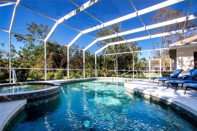 view of swimming pool with a lanai, a patio area, and an in ground hot tub