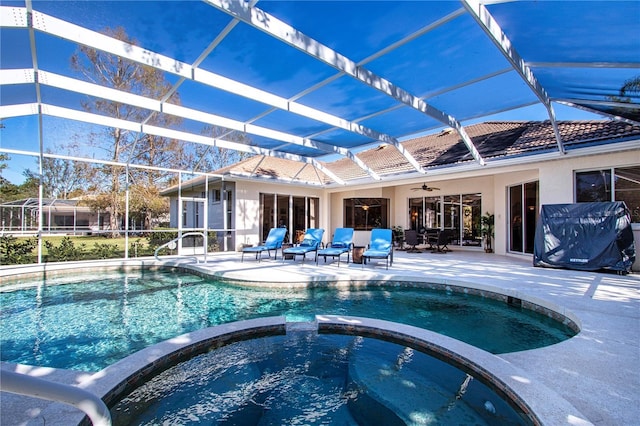 view of pool with an in ground hot tub, a patio, ceiling fan, and a lanai