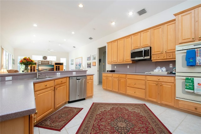 kitchen featuring light brown cabinets, sink, ceiling fan, light tile patterned floors, and stainless steel appliances