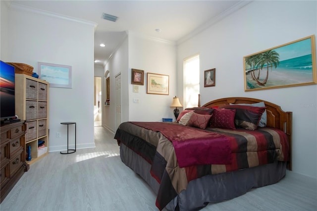 bedroom featuring light hardwood / wood-style flooring and ornamental molding