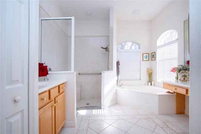 bathroom featuring tile patterned floors, vanity, and separate shower and tub