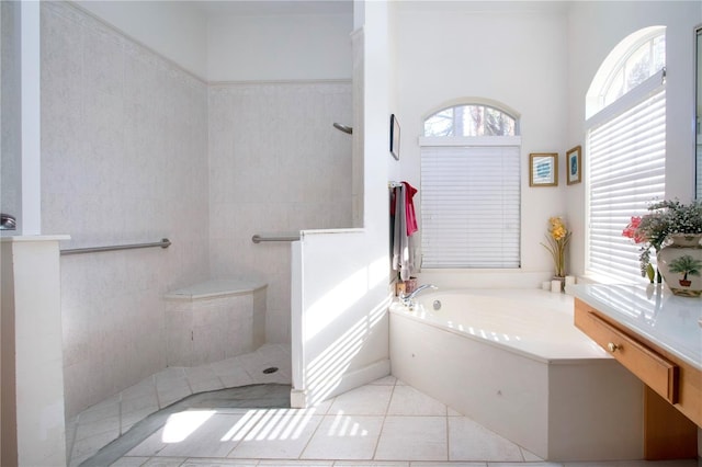 bathroom with shower with separate bathtub, vanity, and tile patterned floors