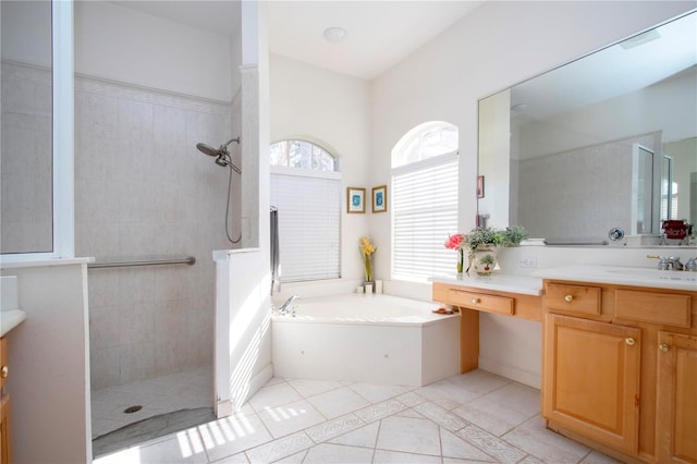 bathroom with tile patterned flooring, vanity, and shower with separate bathtub