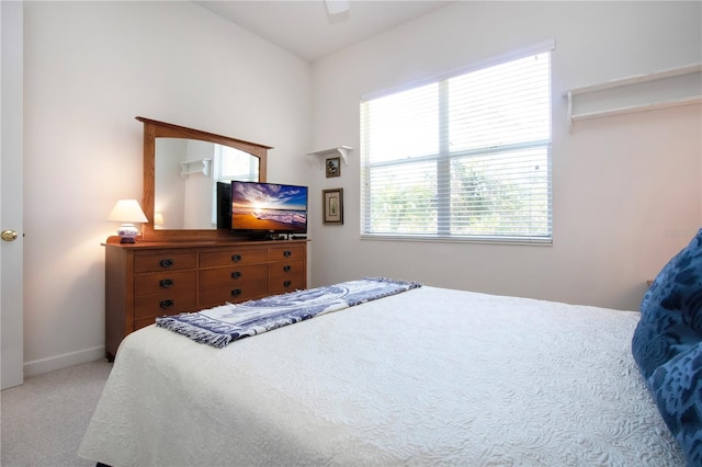 bedroom featuring ceiling fan and light carpet