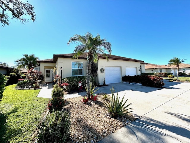 ranch-style home with a garage and a front lawn