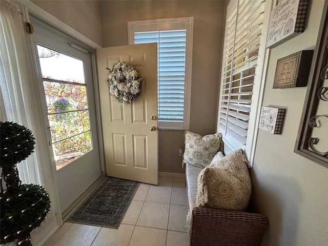 doorway to outside with a healthy amount of sunlight and light tile patterned flooring