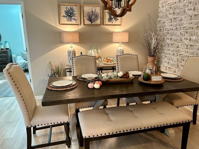 dining room with hardwood / wood-style floors and a notable chandelier