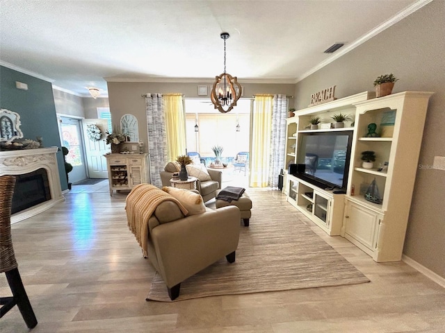 living room with a notable chandelier, light wood-type flooring, and ornamental molding