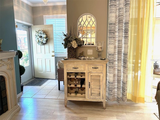 entrance foyer featuring light wood-type flooring and crown molding