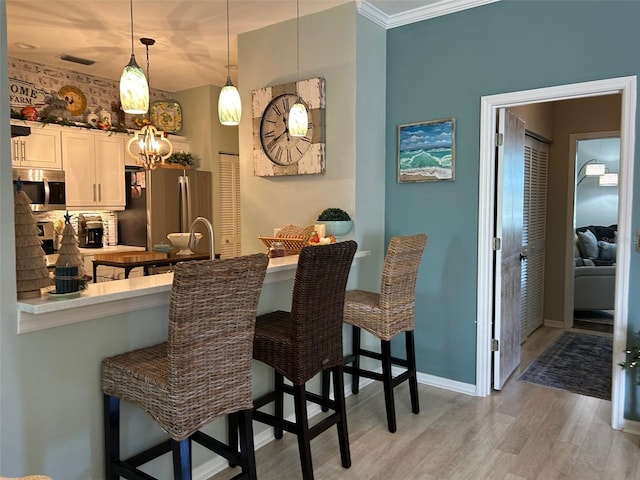 interior space with light hardwood / wood-style floors and crown molding