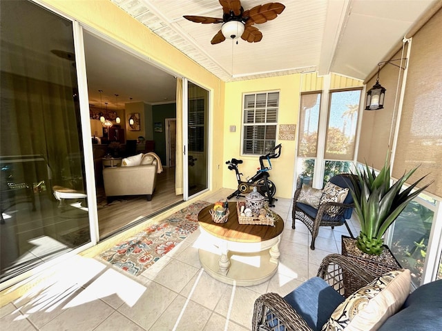 sunroom / solarium with ceiling fan and lofted ceiling