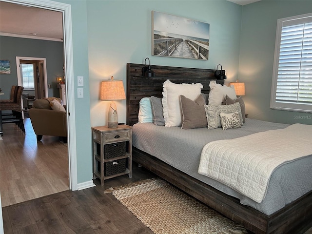 bedroom featuring dark wood-type flooring and ornamental molding