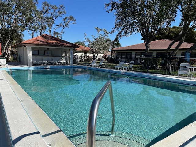 view of pool with an outbuilding