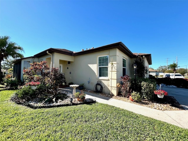 view of front facade featuring a front lawn and stucco siding