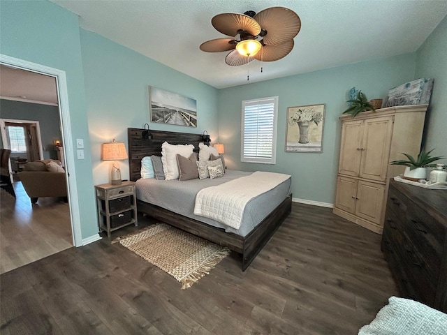 bedroom featuring a ceiling fan, dark wood-style flooring, and baseboards