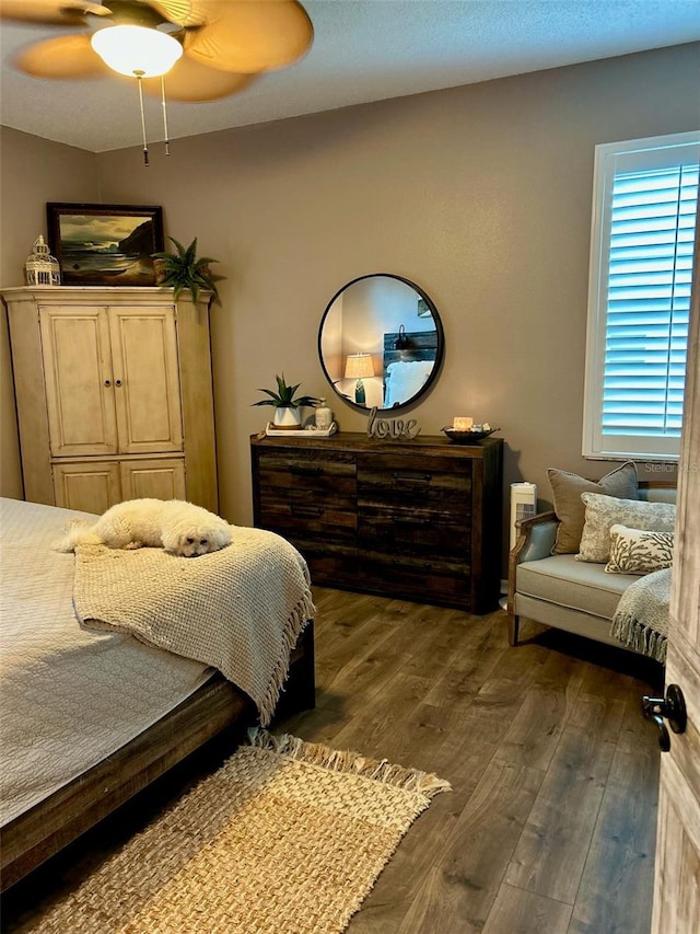 bedroom with dark wood-style floors and ceiling fan