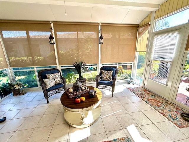 sunroom / solarium featuring lofted ceiling with beams