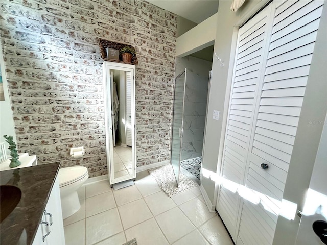 full bath with toilet, a stall shower, vanity, brick wall, and tile patterned flooring