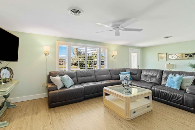 living room with ceiling fan and light hardwood / wood-style flooring