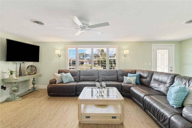 living room featuring ceiling fan and light hardwood / wood-style flooring