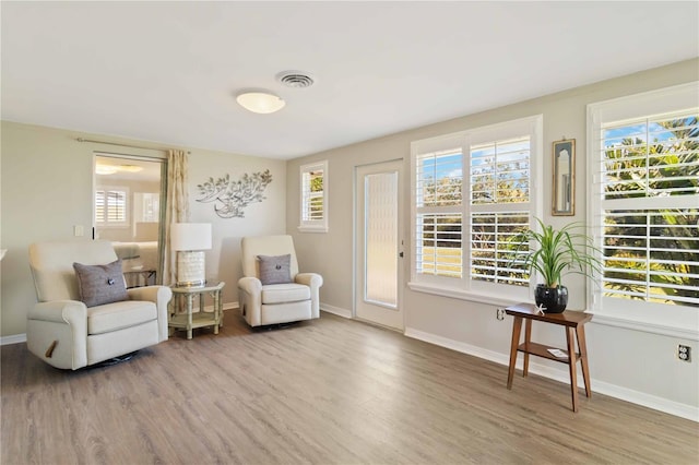 sitting room featuring plenty of natural light and light wood-type flooring