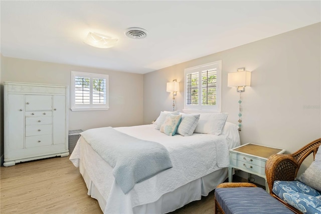 bedroom featuring multiple windows and light wood-type flooring