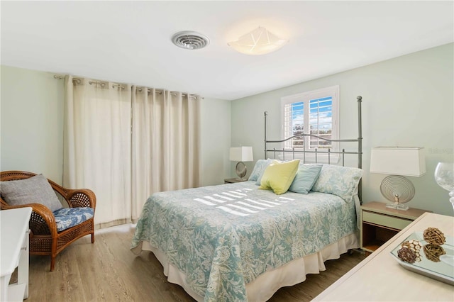 bedroom with hardwood / wood-style floors