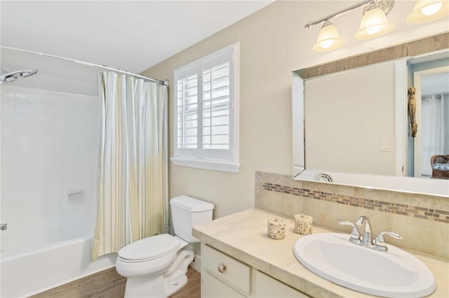 full bathroom with shower / tub combo with curtain, wood-type flooring, decorative backsplash, vanity, and toilet