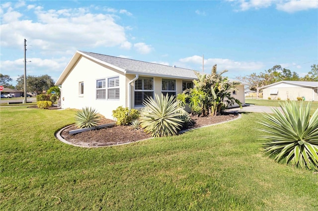 view of side of home with a lawn