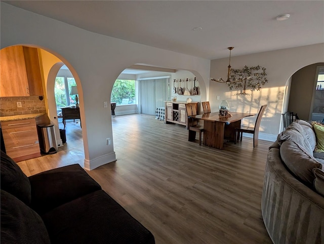 dining space with dark hardwood / wood-style flooring and a chandelier