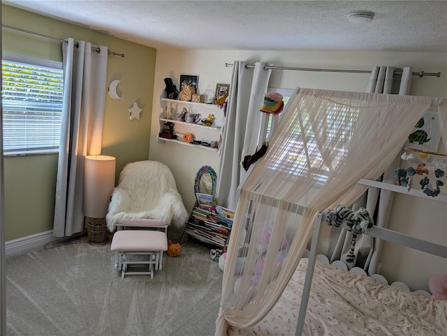 carpeted bedroom featuring a textured ceiling