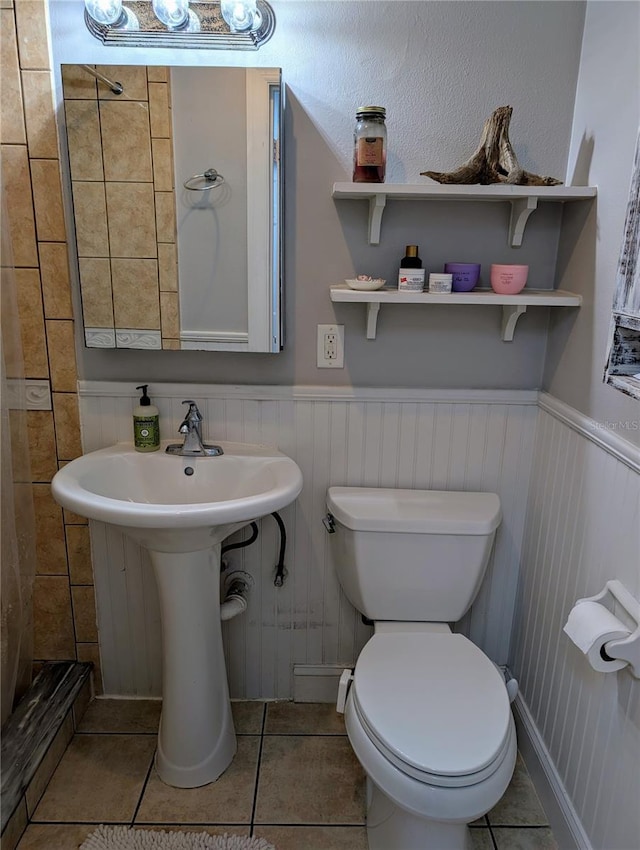 bathroom with tile patterned floors, toilet, and sink