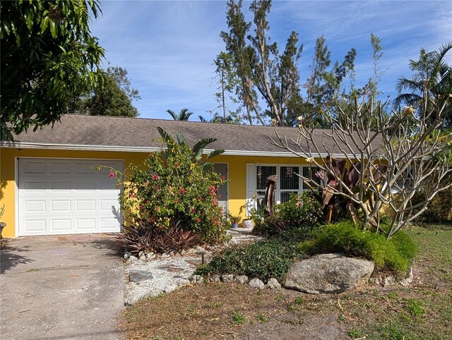 ranch-style home featuring a garage