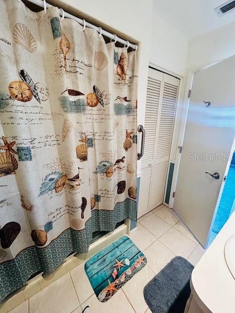 bathroom featuring vanity, a shower with curtain, and tile patterned floors