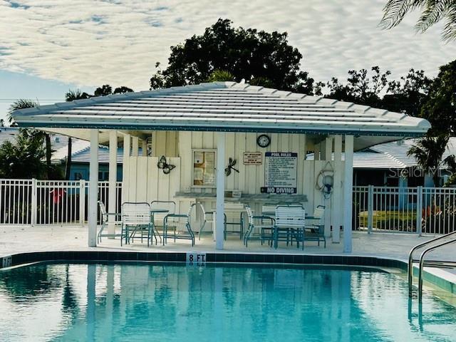 view of pool featuring an outbuilding and a patio