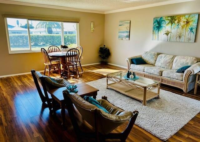 living room featuring crown molding, dark hardwood / wood-style floors, and a textured ceiling