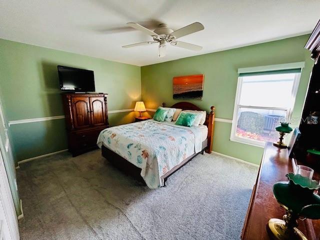 carpeted bedroom with ceiling fan