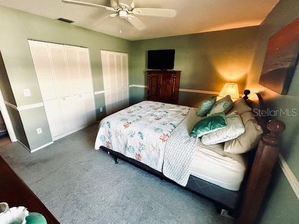 carpeted bedroom featuring ceiling fan