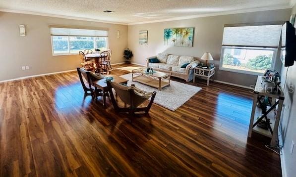 living room with ornamental molding, dark hardwood / wood-style floors, and a textured ceiling