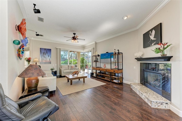 living room featuring ceiling fan, dark hardwood / wood-style flooring, and crown molding